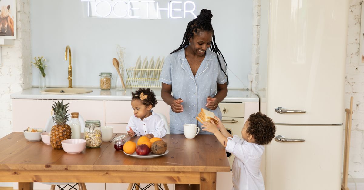 Family at a kitchen table reviewing a household budget after a mortgage payment increase
