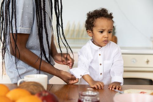 Free Mother and child enjoying a moment at the dining table indoors. Stock Photo