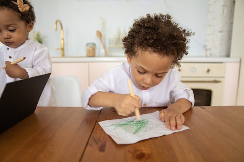 Free A Boy Drawing on a Paper Stock Photo