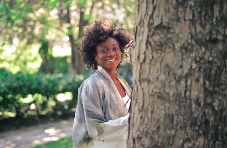 Woman Standing Behind Tree