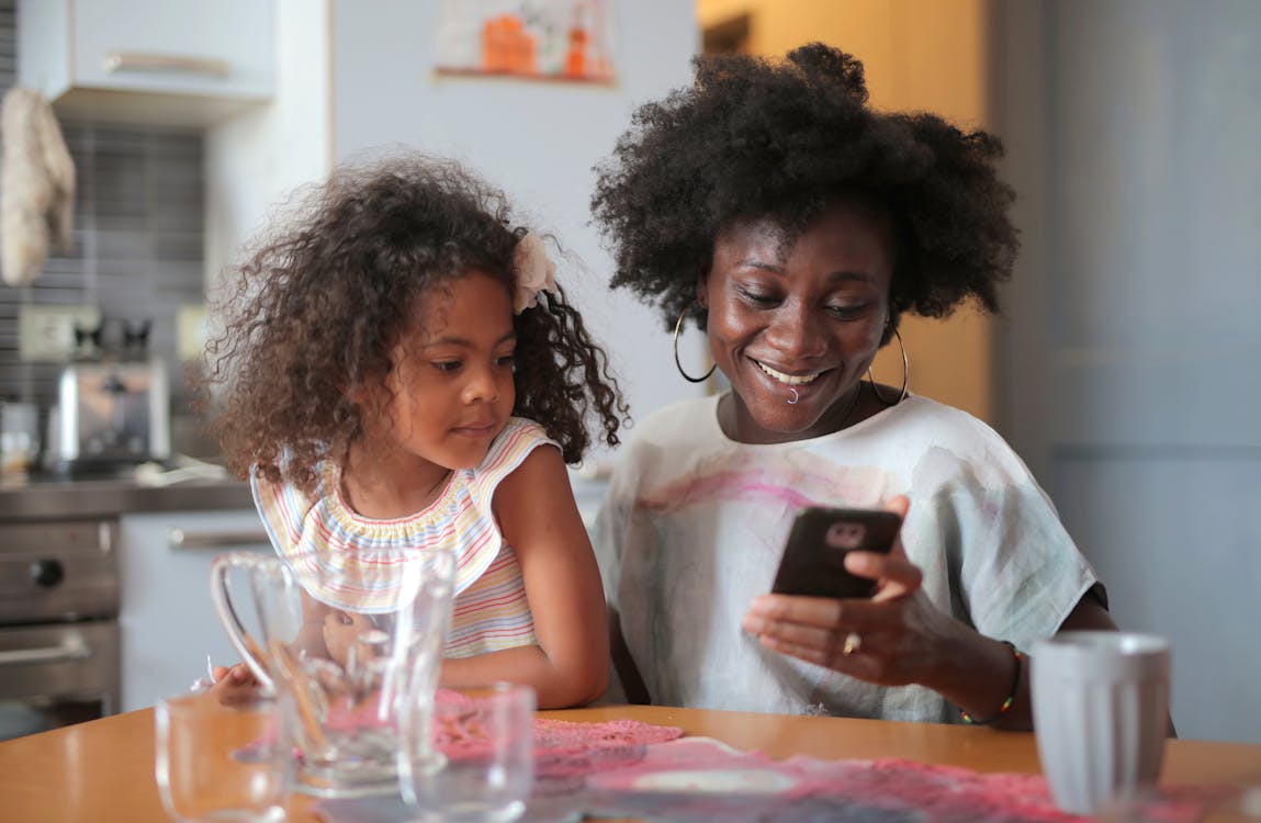 Mother and daughter looking at mobile phone