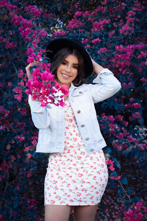 Woman in Denim Jacket Standing near Flowering Plant