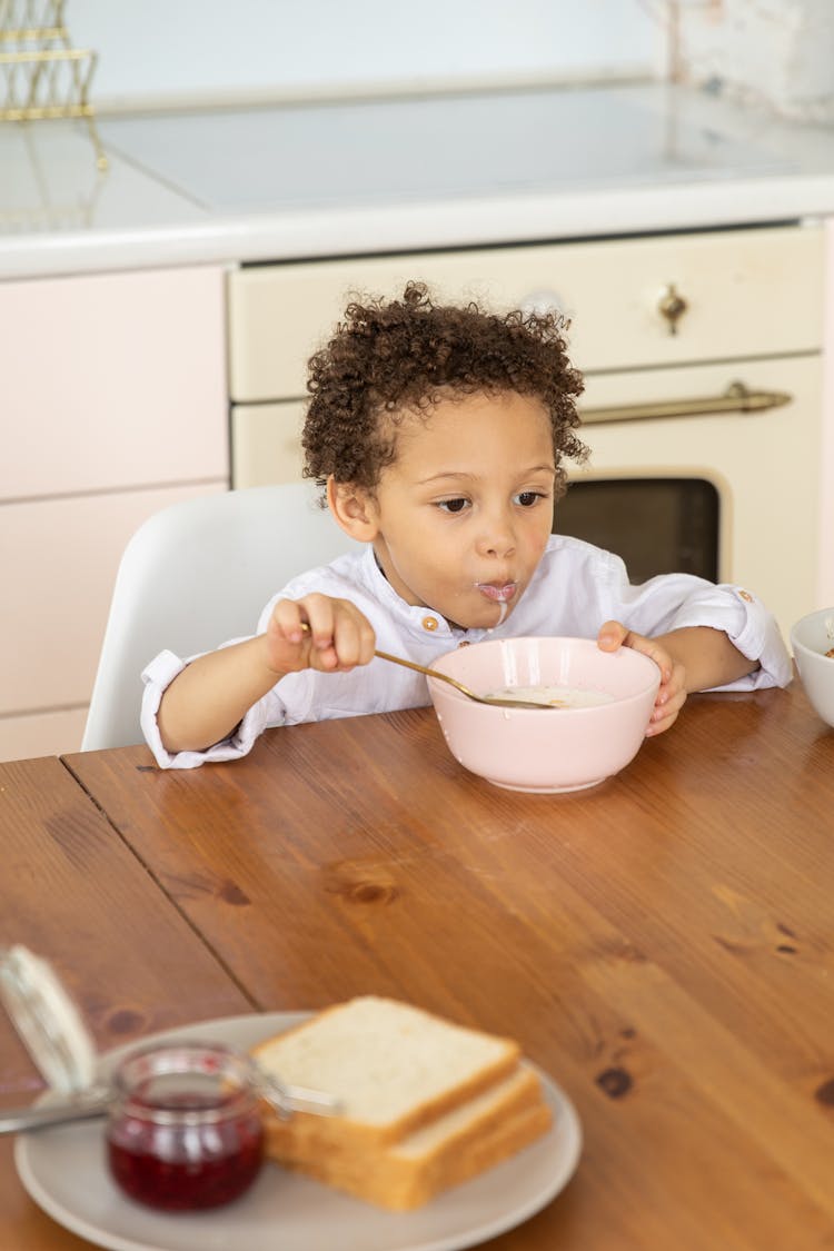 Child Eating From Bowl