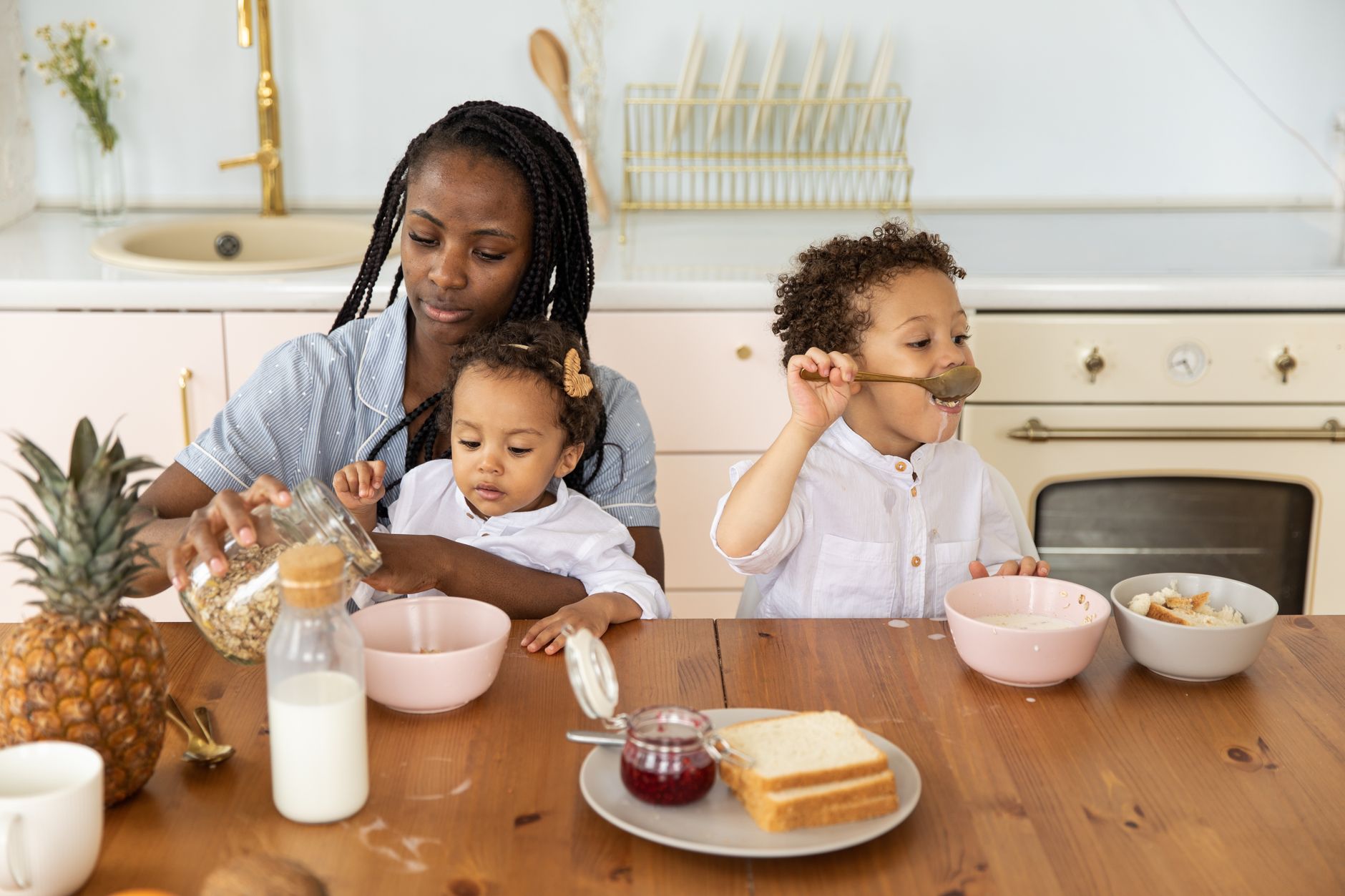A parent preparing healthy breakfast bowls in a bright kitchen, the everyday setting a food and fitness coach works in