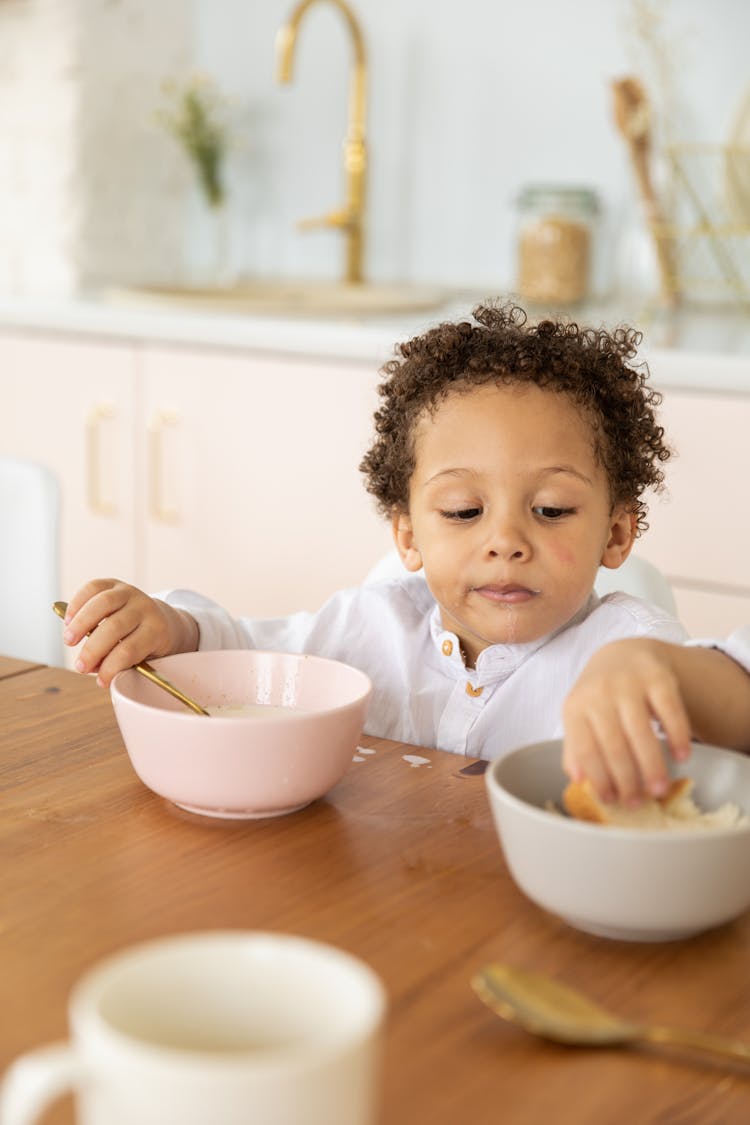 Little Boy Eating With His Hands 