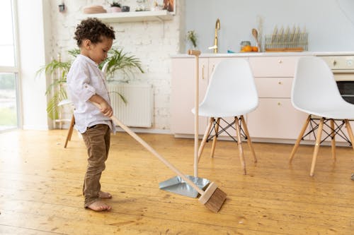 Free Little Kid Sweeping Floor  Stock Photo