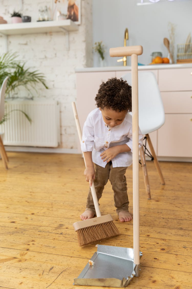 Photo Of A Boy Cleaning The Floor