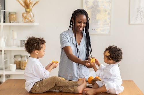 Free Woman Giving Fruits to her Children  Stock Photo