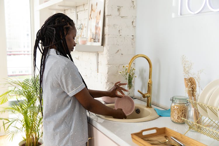 Woman Washing The Dishes 