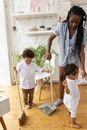 Woman Cleaning Room with Children