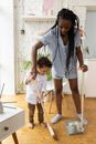 Mother Cleaning Flat with her Daughter
