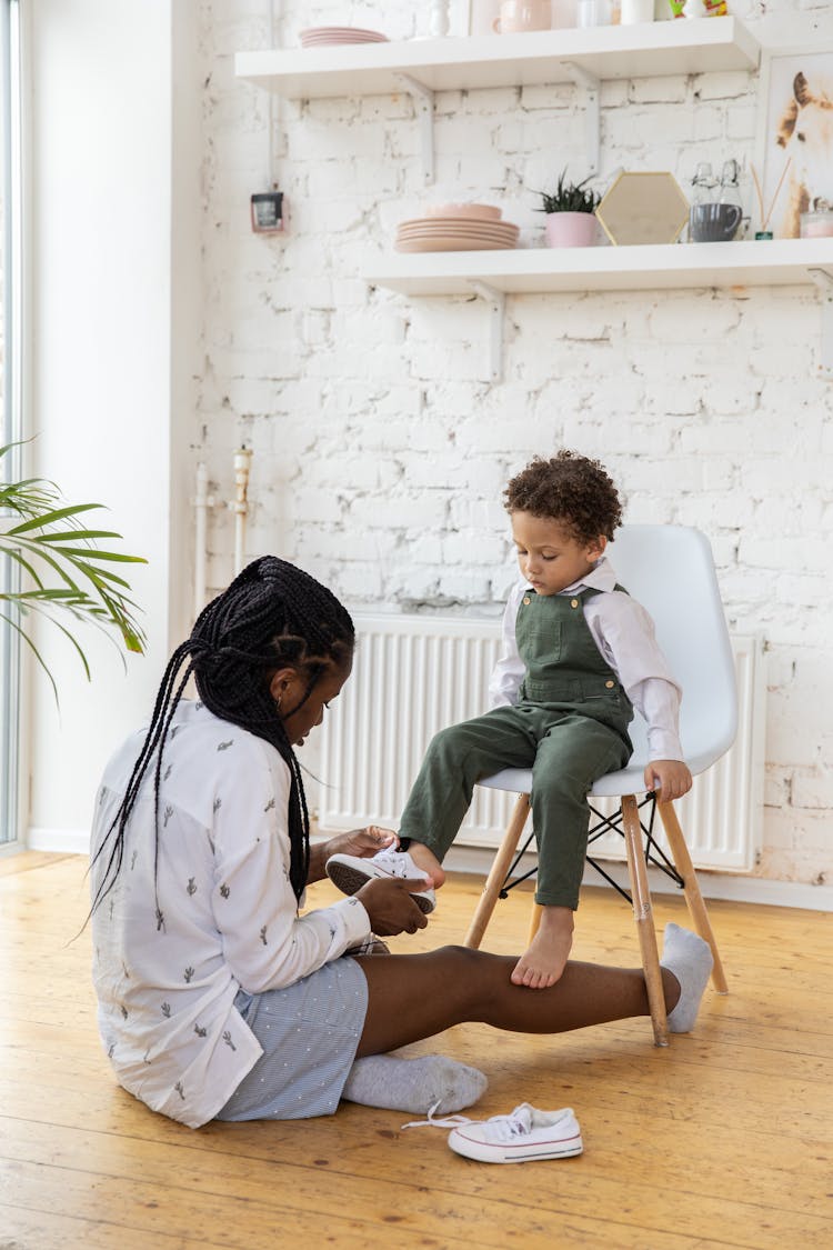 Mother Wearing Shoes To Child