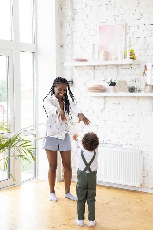 Free Delightful moment of a mother and child playing together indoors with joyful expressions. Stock Photo