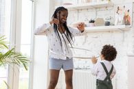Woman in White Shirt and Blue Denim Shorts Standing Beside Woman in White Shirt