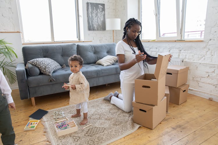 Woman Busy With Cardboard Boxes In Living Room