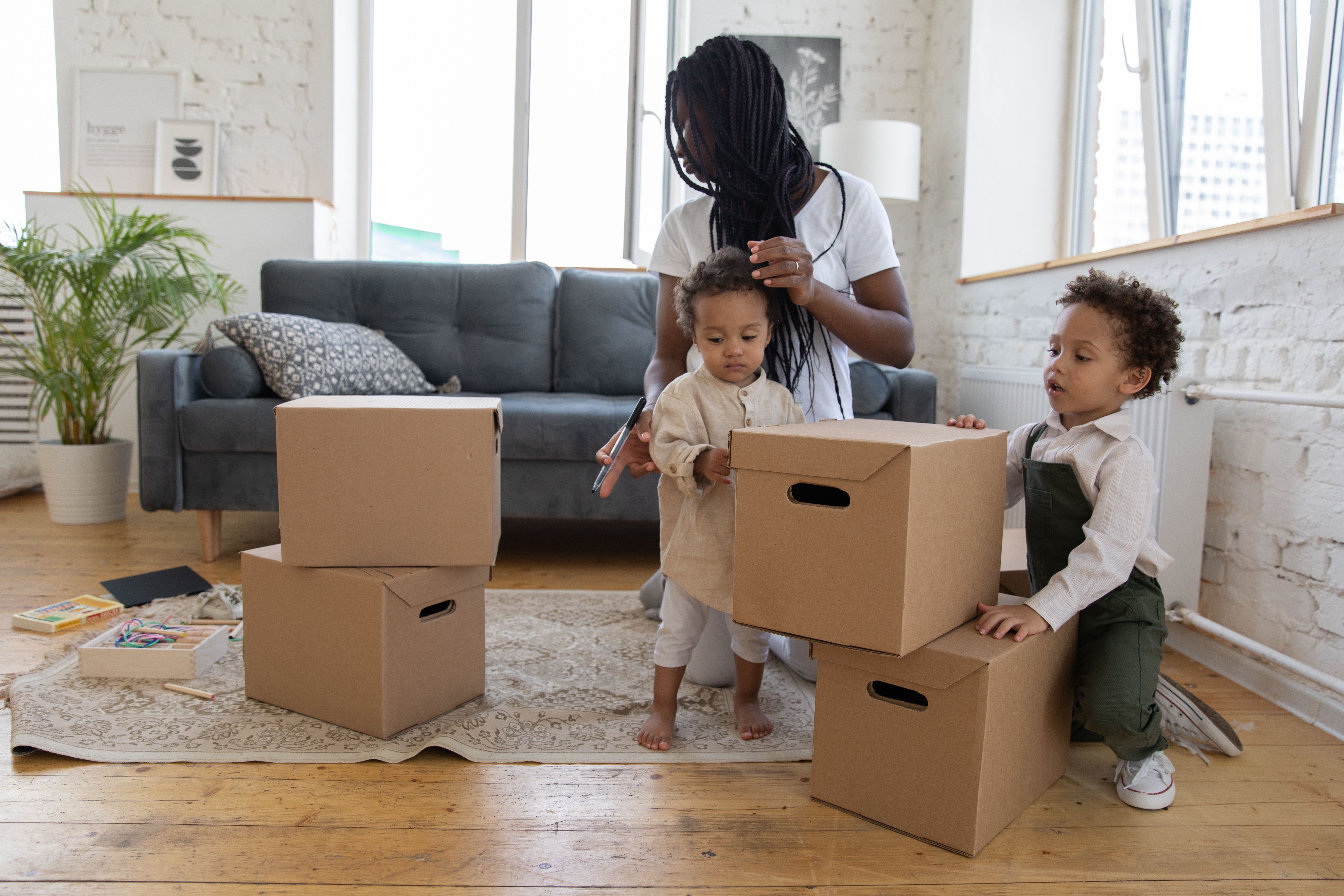 Family packing moving boxes at home for a September move to Litchfield Park