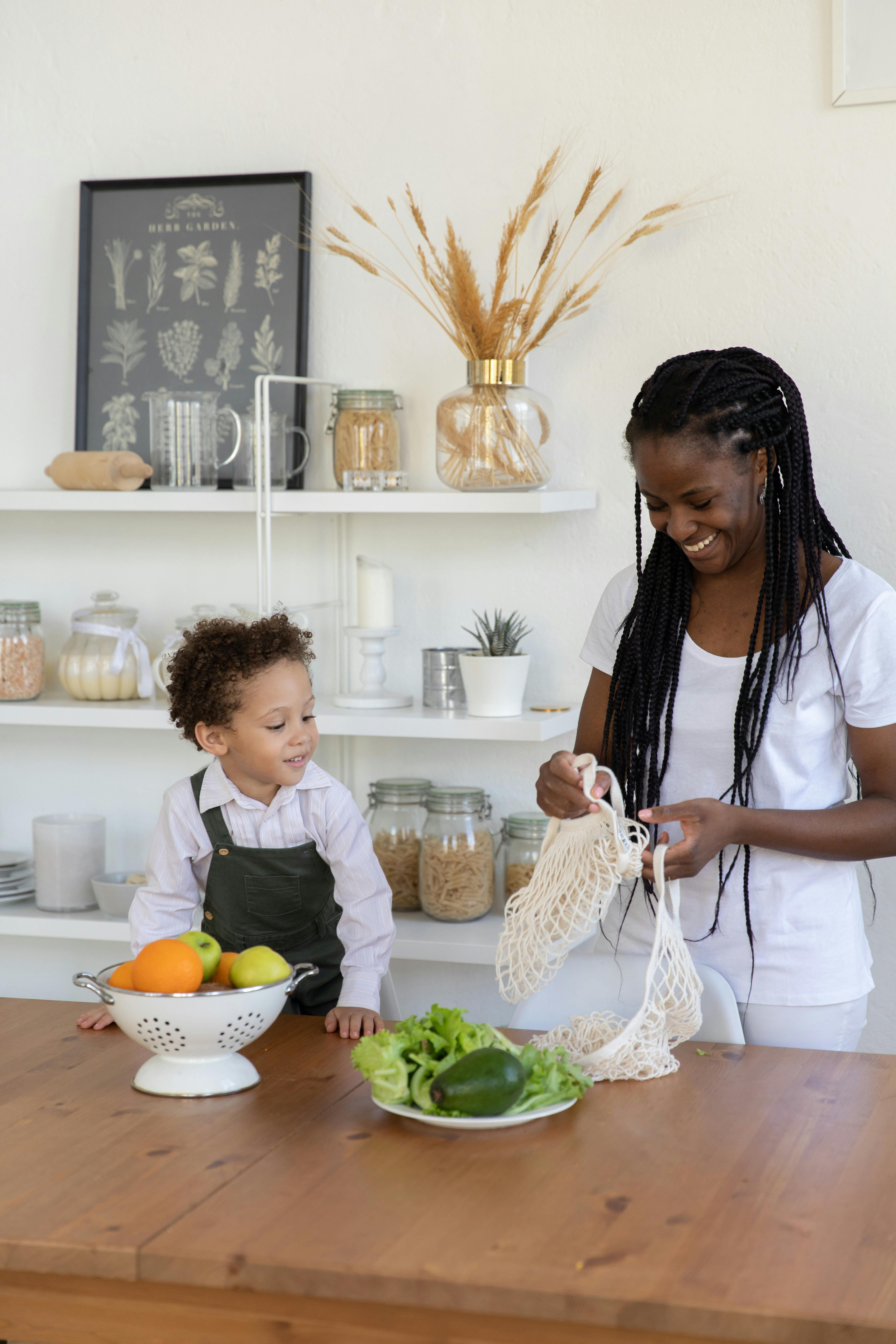 mother and son unpacking groceries