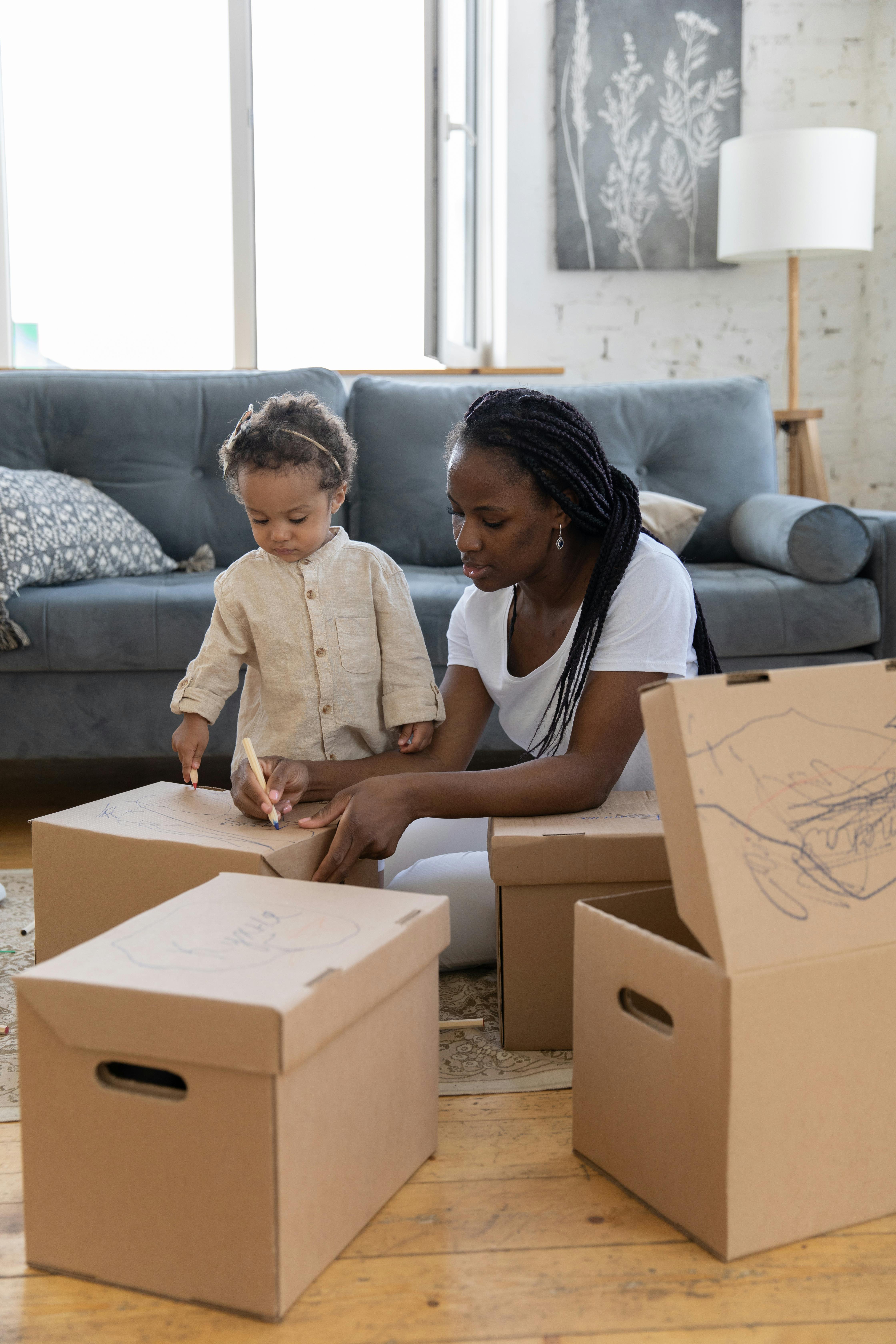 mother and child writing on boxes