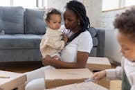 Upset Little Girl Held by Mother