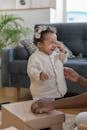 Girl in White Button Up Shirt Sitting on Brown Wooden Table