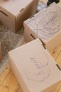 White Cardboard Box on Brown Wooden Floor