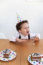 Boy in White Dress Shirt Sitting on Brown Wooden Table