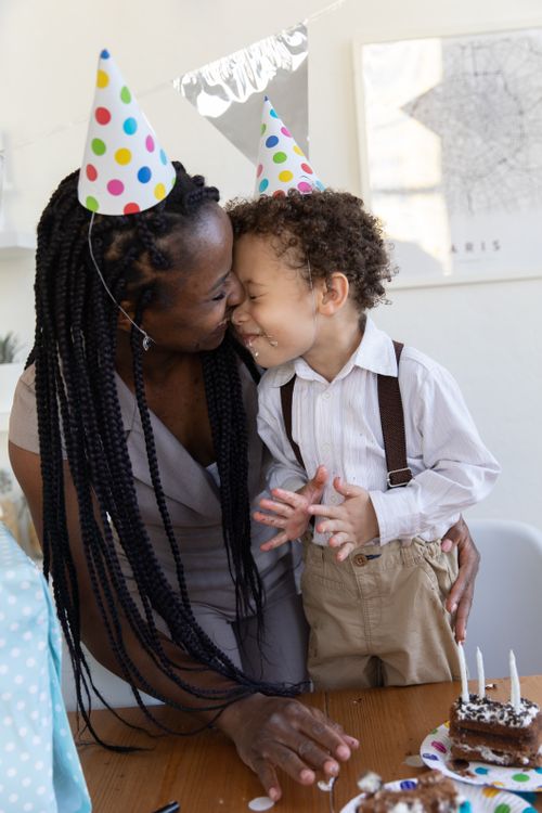 Free A joyful mother and son sharing a loving moment during a birthday celebration with cake. Stock Photo