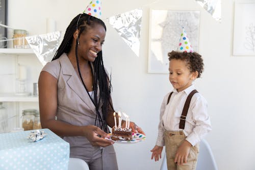 Free Braided Woman Carrying a Slice of Cake with Candles Stock Photo