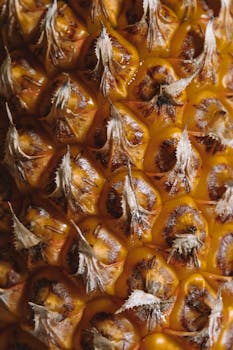 Extreme close-up of a ripe pineapple surface showing its unique texture.