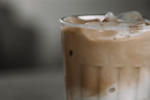 Free Close-up of a refreshing iced coffee in a glass, showcasing the layers of cream and coffee. Stock Photo
