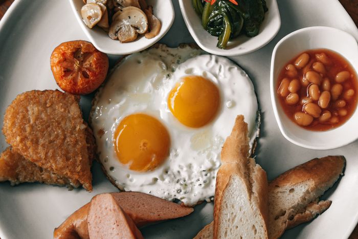 Plate of fried eggs with toast and sides — photo by ROMAN ODINTSOV on Pexels