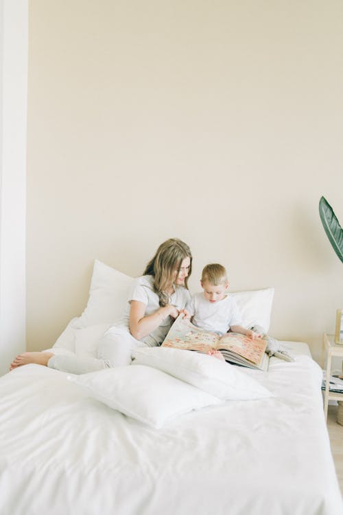 Free Mother And Child Sitting On The Bed Stock Photo