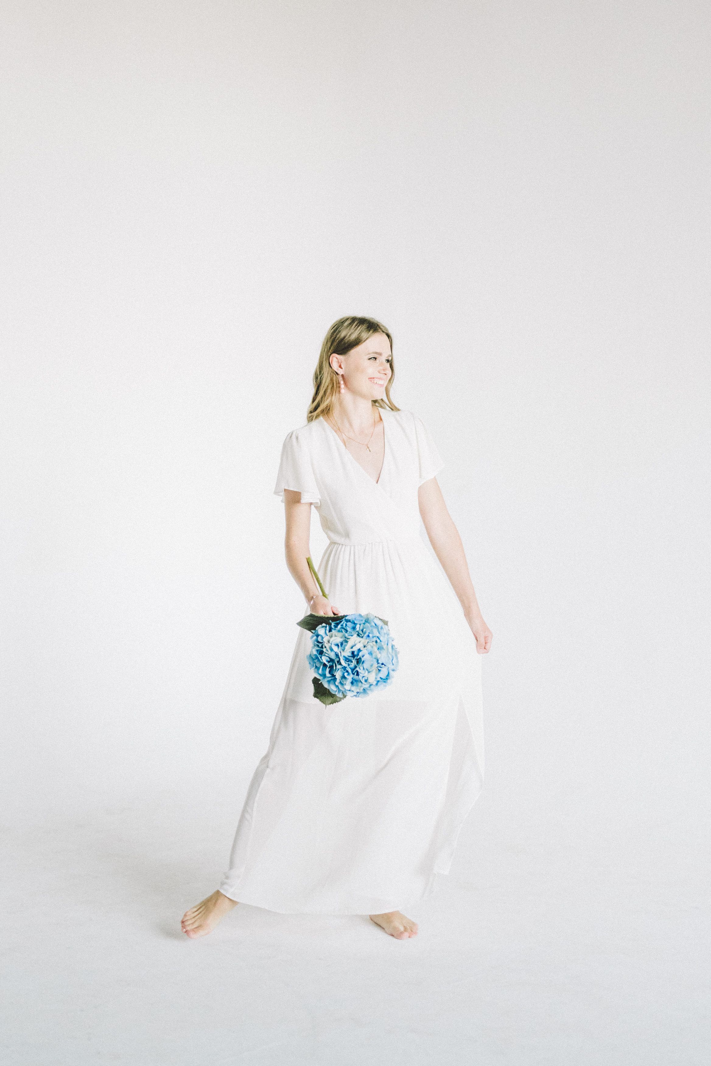 Woman In White Dress Holding Bouquet Of Flowers · Free Stock Photo