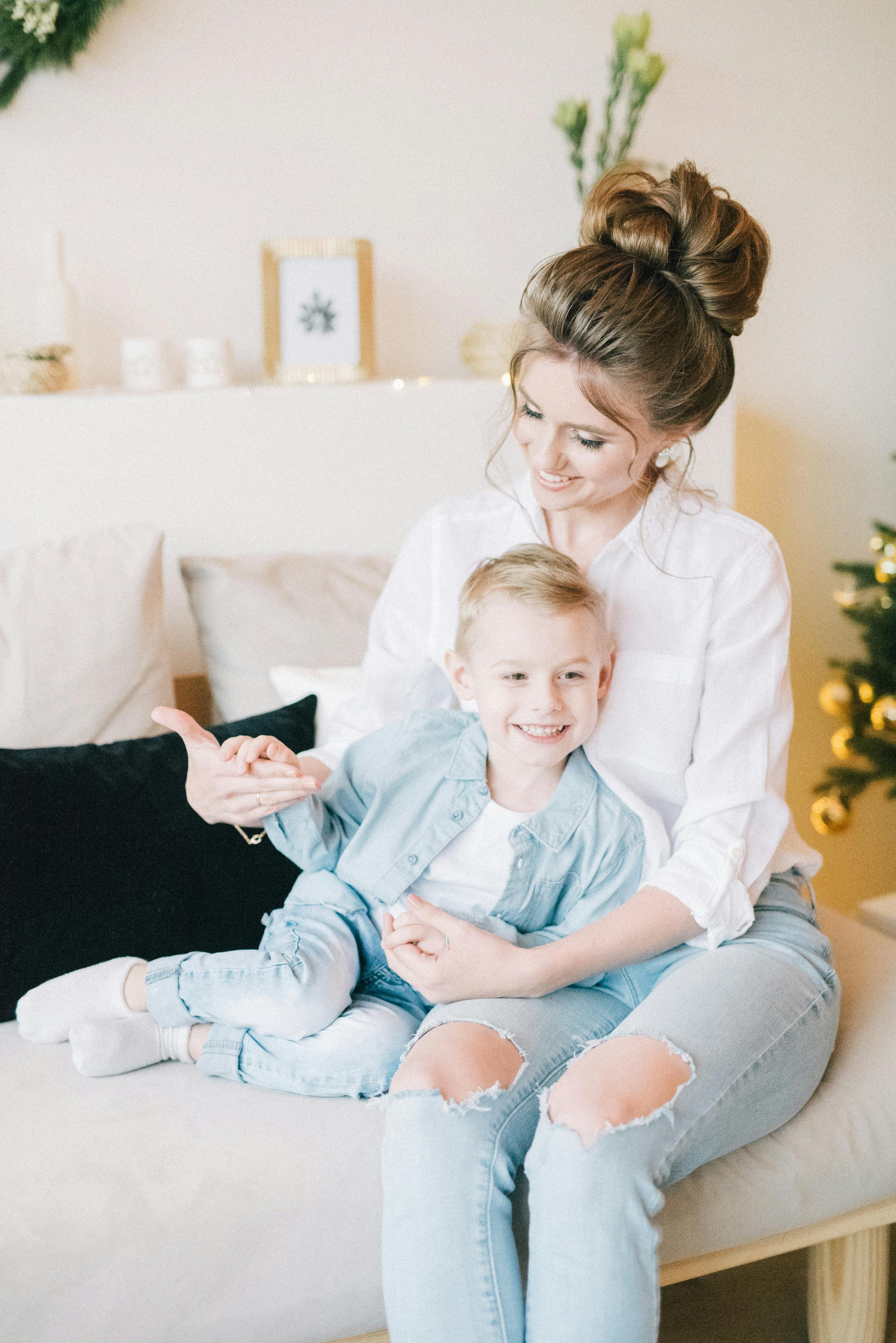 woman in white dress shirt sitting beside boy