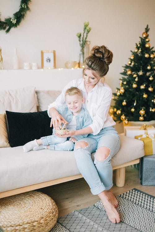 Free Woman In White Long Sleeve Top Sitting On The Couch Stock Photo