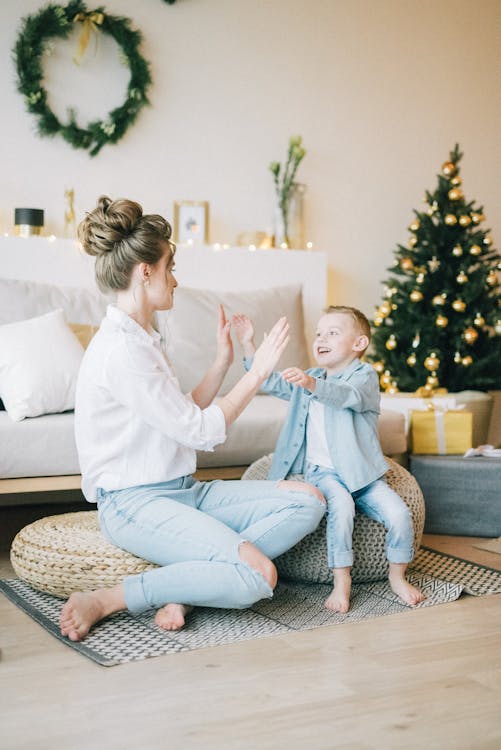 Woman In White Long Sleeve Top Playing With Her Child