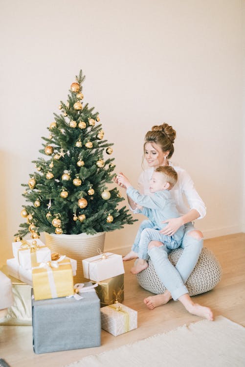 Free Mother And Child Decorating The Tree Stock Photo