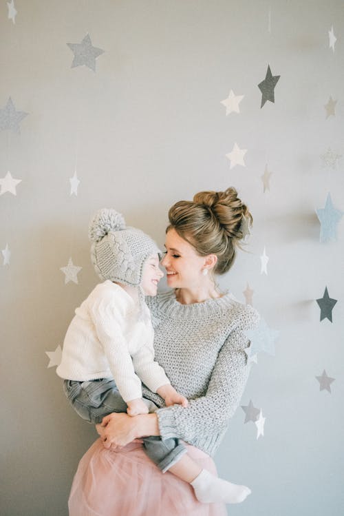 Woman In Sweater Hugging Carrying A Child