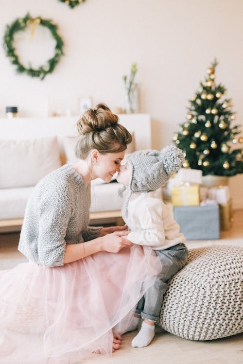 Free Woman Wearing A Sweater With Her Child Stock Photo