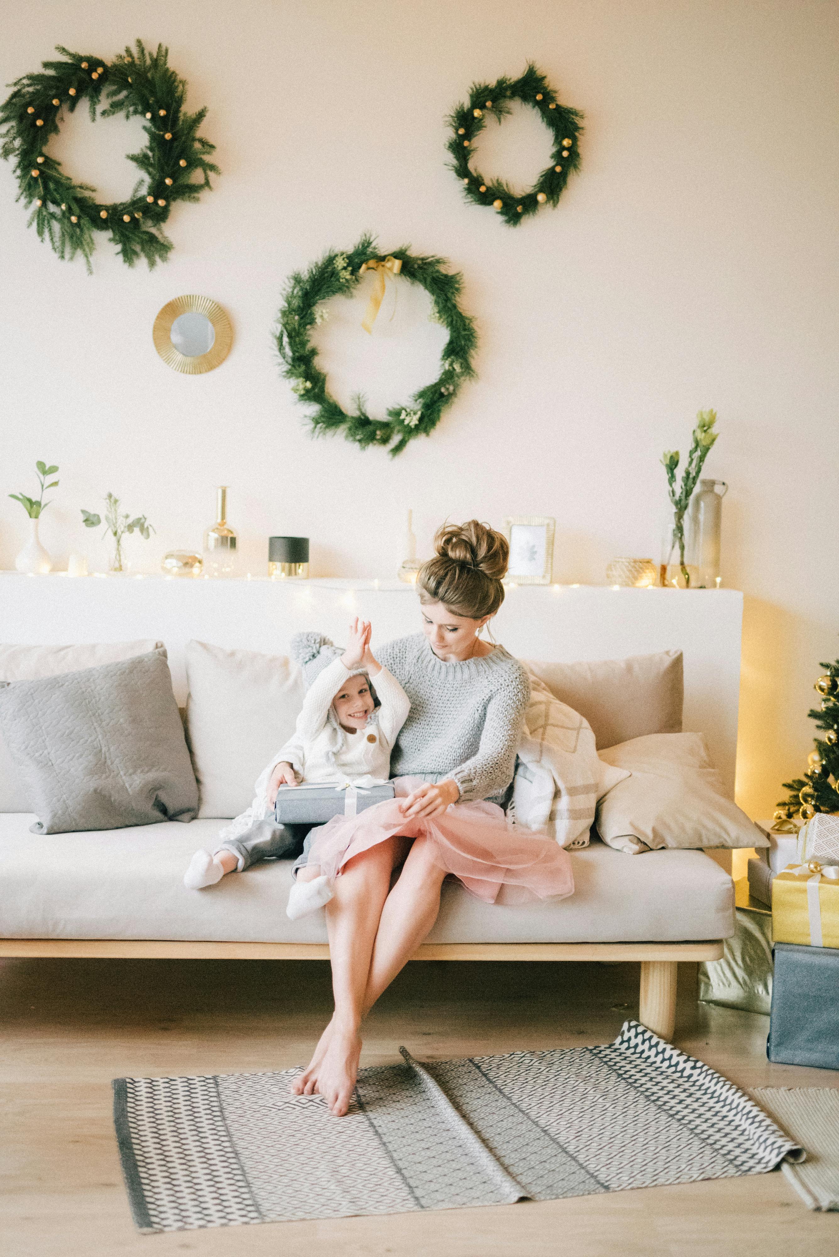 a mother sitting on the couch with her son