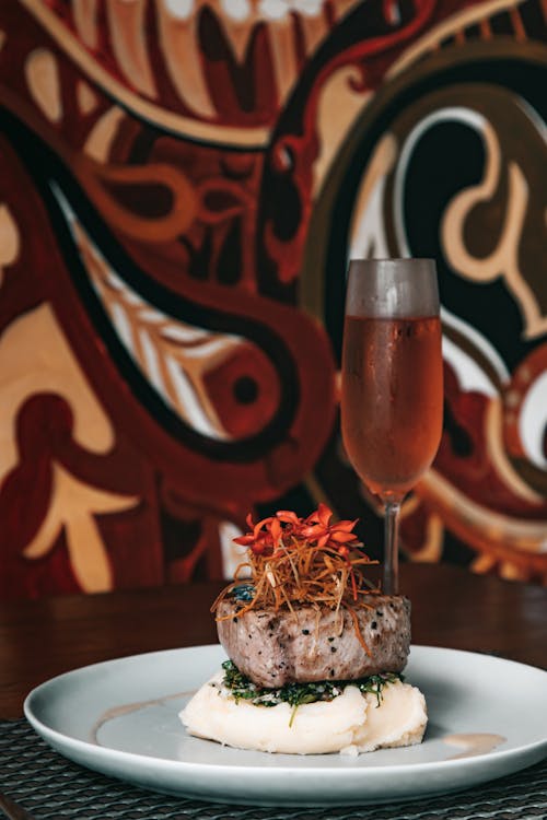 Free Gourmet Dish beside a Glass of Champagne Stock Photo