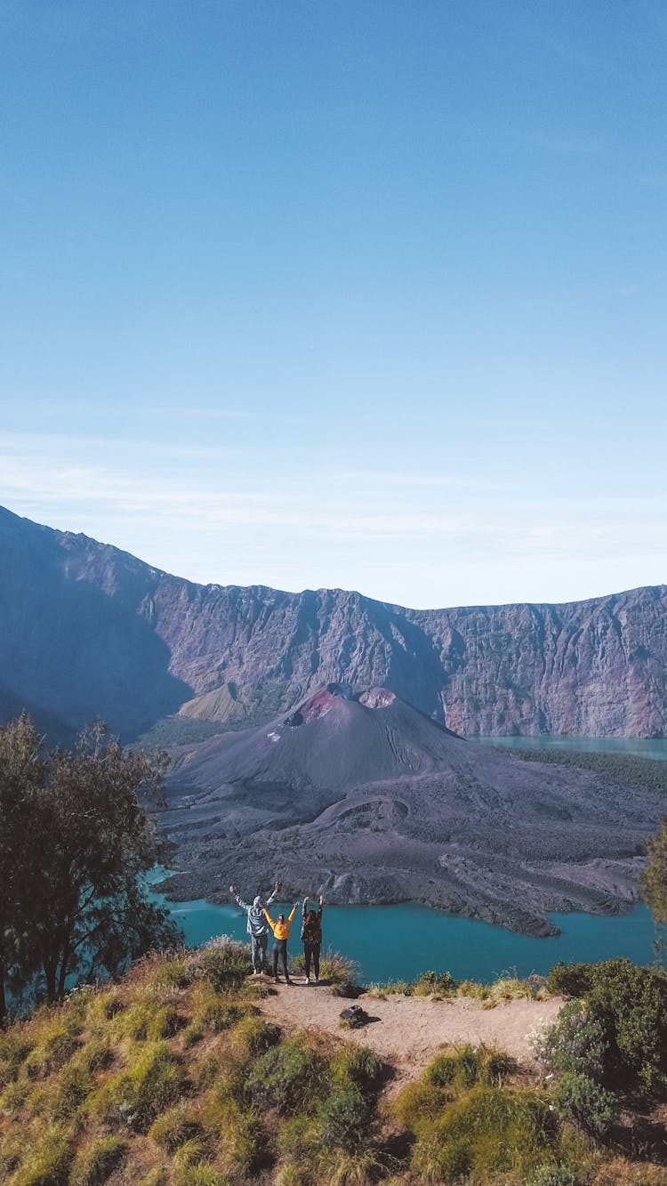 People On Top Of Hill With View On River And Mountains