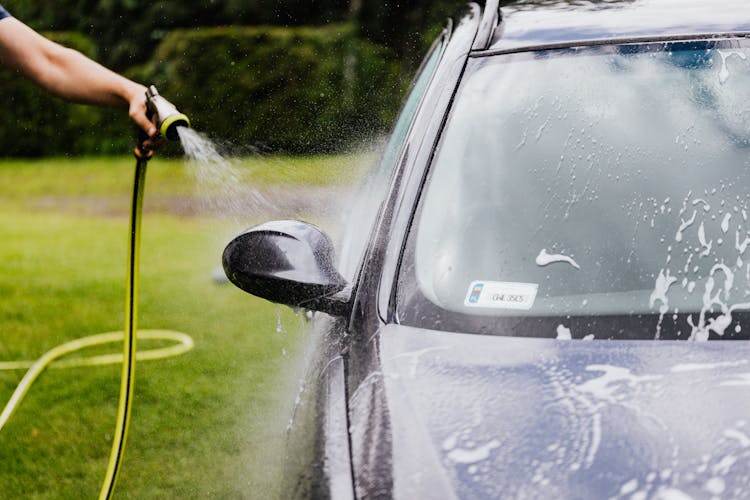 
A Person Washing A Car