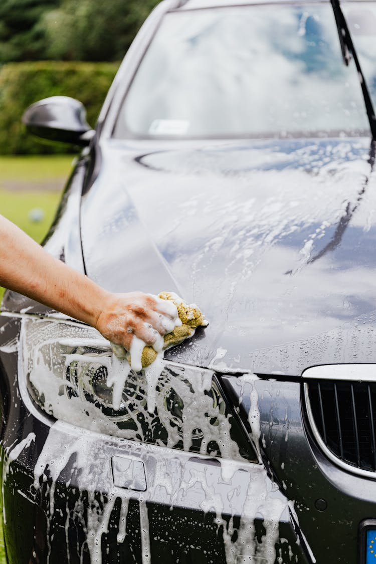 Person Cleaning A Black Car 