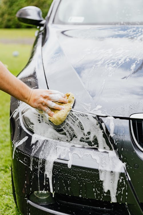 Free Person cleaning a Black Car Stock Photo
