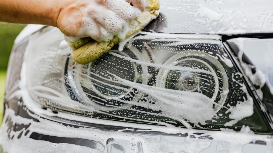 Foam and a wash mitt on a coated hood during a maintenance wash