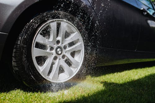 
Water being Sprayed on a Wheel of a Car