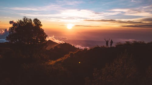 Sun over People on Top of Hill