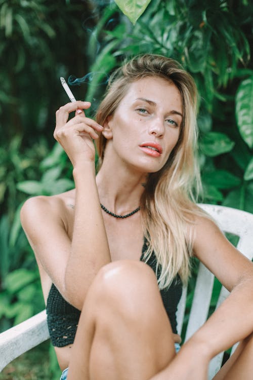 Free Portrait of a Woman with Blond Hair Smoking a Cigarette Stock Photo