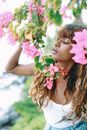 Woman in Pink Sleeveless Top Holding Pink Flower